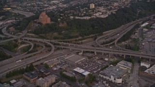 AX50_064 - 5K aerial stock footage of the I-5 / I-90 interchange by Pacific Tower in Beacon Hill, Seattle, Washington, sunset