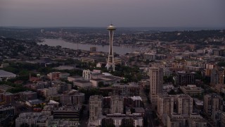 AX50_073E - 5K aerial stock footage tilt from Elliott Bay to reveal the Seattle Space Needle and Central Waterfront piers in Downtown Seattle, Washington, sunset