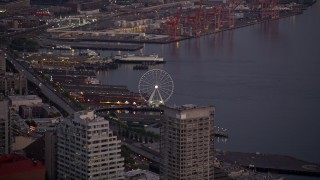 AX50_079 - 5K aerial stock footage track the Seattle Great Wheel behind the Seattle Aquarium, Downtown Seattle, Washington, sunset