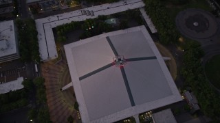 AX50_080 - 5K aerial stock footage tilt to a bird's eye view of the KeyArena multi-purpose facility, Downtown Seattle, Washington, sunset