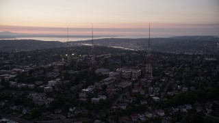 AX50_081 - 5K aerial stock footage flyby Queen Anne High School between radio towers Queen Anne, Seattle, Washington, sunset 
