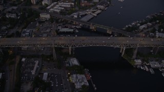 AX50_084 - 5K aerial stock footage of bird's eye view of light traffic crossing the Ship Canal Bridge, Seattle, Washington, twilight