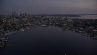 AX50_088E - 5K aerial stock footage fly over the Capitol Hill neighborhood and Lake Union to approach Downtown Seattle skyline, twilight
