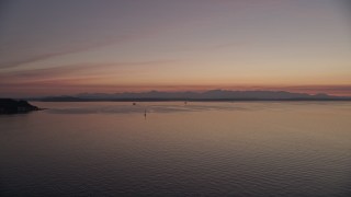 AX50_093 - Aerial stock footage of Puget Sound with skies lit by the sunset, Seattle, Washington