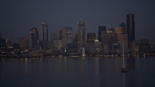 AX50_095 - 5K aerial stock footage orbit sailboat to reveal Downtown Seattle skyline, Washington, twilight