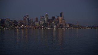 AX50_096E - 5K aerial stock footage of low approach to Downtown Seattle skyline at twilight, Washington