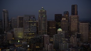 AX50_098 - 5K aerial stock footage of approach and flyby 1201 Third Avenue Tower at twilight in Downtown Seattle, Washington