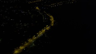 AX51_002 - 5K aerial stock footage tilt to Rainer Avenue with light traffic in Lakeridge, Washington, night