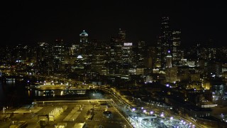 AX51_008 - 5K aerial stock footage of Downtown Seattle skyscrapers at night seen from CenturyLink Field, Washington
