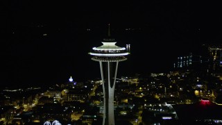 AX51_028 - 5K aerial stock footage orbit top of the Seattle Space Needle at night, Downtown Seattle, Washington