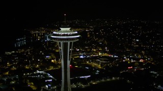 AX51_028E - 5K aerial stock footage orbit top of the Seattle Space Needle at night, Downtown Seattle, Washington
