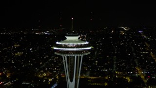 AX51_031E - 5K aerial stock footage orbit Space Needle in Downtown Seattle, with Elliott Bay and downtown in the background, Washington, night