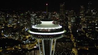 AX51_032 - 5K stock footage aerial video of close-up orbit of the top of the Space Needle at night in Downtown Seattle, Washington