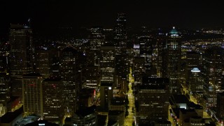 AX51_033E - 5K aerial stock footage approach and fly over Downtown Seattle skyscrapers and high-rises at night, Washington