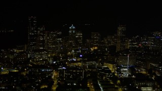 AX51_036E - 5K aerial stock footage flyby and approach Downtown Seattle skyscrapers and high-rises at night, Washington