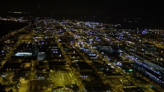 AX51_049 - 5K aerial stock footage pan across warehouses and industrial buildings in the SoDo District, Seattle, Washington, night