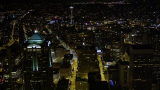 AX51_051E - 5K aerial stock footage fly over skyscrapers in Downtown Seattle to approach the Space Needle, Washington, night