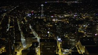 AX51_052 - 5K stock footage aerial video fly over skyscrapers in Downtown Seattle to approach the Space Needle, Washington, night