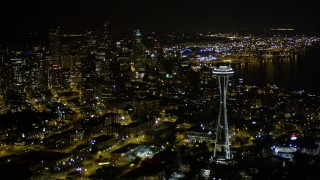 AX51_067E - 5K aerial stock footage flyby the Space Needle to approach Downtown Seattle skyscrapers, Washington. night