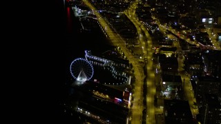 AX51_071 - 5K aerial stock footage orbit the Seattle Great Wheel, Central Waterfront piers, and Alaskan Way Viaduct in Downtown Seattle, Washington, night