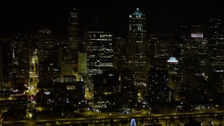 AX51_072E - 5K aerial stock footage of passing skyscrapers and high-rises in Downtown Seattle, Washington, night