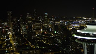 AX51_075 - 5K aerial stock footage orbit top of the Space Needle to reveal and focus on Downtown Seattle skyscrapers, Washington, night