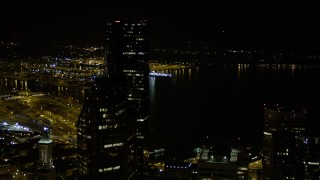 AX51_082E - 5K aerial stock footage approach Seattle Municipal Tower and Columbia Center in Downtown Seattle, Washington, at night