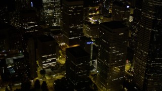 AX51_086E - 5K aerial stock footage reveal base of Rainier Tower in Downtown Seattle, Washington, night