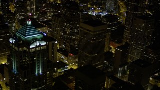 AX51_088E - 5K aerial stock footage flyby 1201 3rd Avenue Tower to reveal base of Rainier Tower in Downtown Seattle, Washington, night