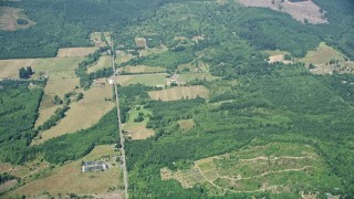 AX52_013 - 5K aerial stock footage fly away from farms in Silver Creek, Washington