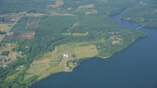 AX52_016 - 5K aerial stock footage fly away from farms, fields, and Mayfield Lake in Silver Creek, Washington