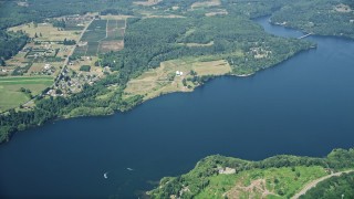 AX52_016E - 5K aerial stock footage fly away from farms, fields, and Mayfield Lake in Silver Creek, Washington