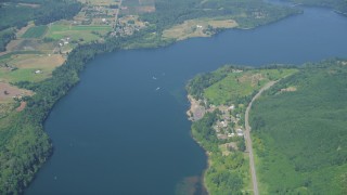 AX52_017 - 5K stock footage aerial video of reverse view of boats in Mayfield Lake, rural homes on shore, Washington
