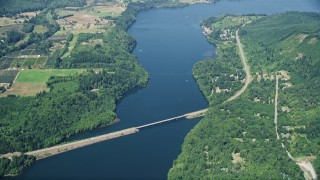 AX52_018E - 5K aerial stock footage of reverse view of Mayfield Lake, reveal Highway 12 bridge, Washington