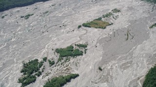 AX52_026 - 5K aerial stock footage of reverse view of the North Fork Toutle River, full of sediment, in Washington
