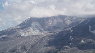 AX52_045 - 5K aerial stock footage of Mount St. Helens crater with cloud cover, Washington