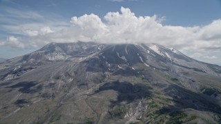 AX52_046 - 5K stock footage aerial video approach cloud-capped Mount St. Helens with patches of snow, Washington