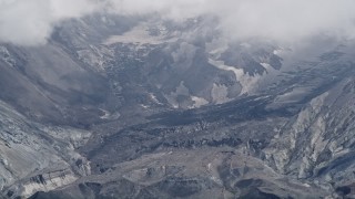 AX52_048 - 5K aerial stock footage of a close-up look inside the Mount St. Helens crater with low clouds, Washington