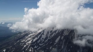 AX52_054 - 5K aerial stock footage video of snow on the slope of Mount St. Helens and low clouds, Washington