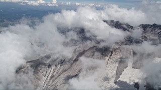 AX52_060 - 5K aerial stock footage orbit the Mount St. Helens crater with snow and low clouds, Washington