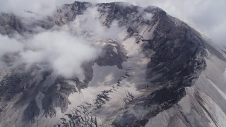 AX52_063 - 5K stock footage aerial video of a view of the Mount St. Helens crater with low hanging clouds, Washington