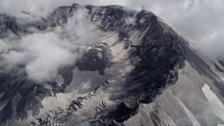 AX52_064 - 5K aerial stock footage pan across and flyby the Mount St. Helens crater and clouds, Washington