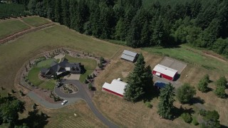 AX52_076 - 5K aerial stock footage of a large farmhouse with red barns, La Center, Washington