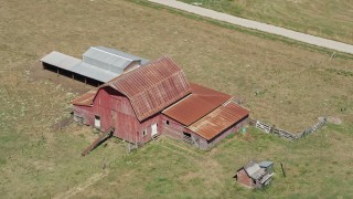 AX52_077E - 5K aerial stock footage approach and flyby an old red barn in a farm field in La Center, Washington