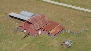 AX52_078 - 5K stock footage aerial video of old red barn in the middle of farm fields in La Center, Washington