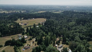 AX52_079 - 5K aerial stock footage fly over farms, fields, and evergreen trees in La Center, Washington