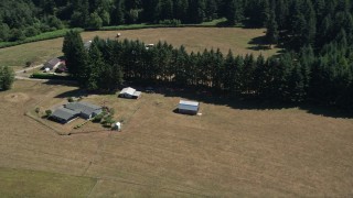 AX52_080 - 5K aerial stock footage of small barn next to a farmhouse in La Center, Washington