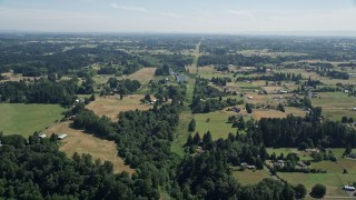AX52_084 - 5K aerial stock footage of small farms and fields with trees in Ridgefield, Washington