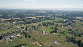 AX52_085 - 5K aerial stock footage fly over small farms and farm fields in Ridgefield, Washington