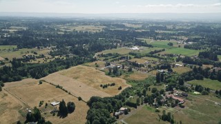 AX52_086 - 5K aerial stock footage fly over farms with green and brown farm fields in Ridgefield, Washington